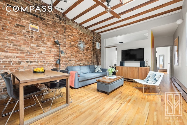 living room featuring beamed ceiling, brick wall, a baseboard heating unit, and hardwood / wood-style floors