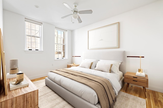 11 E 68th St Unit 7Ce, New York City, NY 10021 - bedroom with light wood-type flooring, baseboards, and a ceiling fan