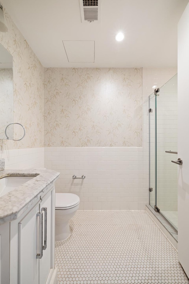 full bath with tile patterned flooring, visible vents, vanity, toilet, and a shower stall