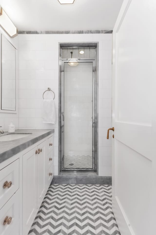 1133 Park Ave Unit 2W, New York City, NY 10128 - bathroom featuring vanity, tile patterned floors, and a stall shower