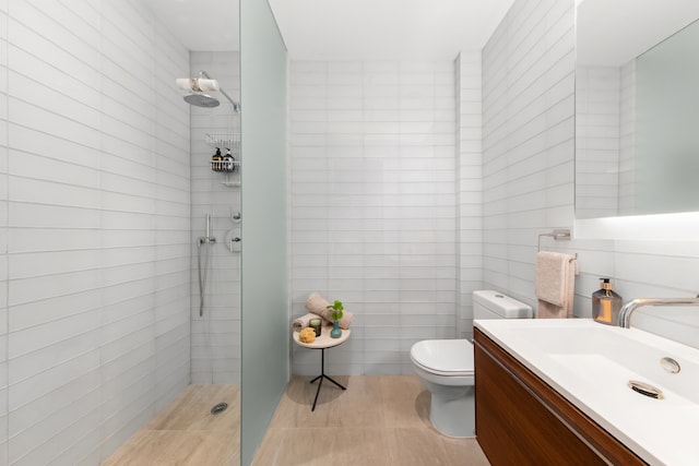 123 3rd Ave Unit Ph18, New York City, NY 10003 - bathroom with a walk in shower, toilet, tile walls, vanity, and tile patterned floors