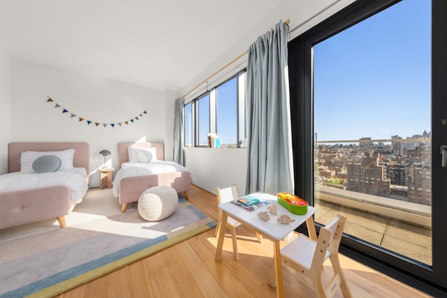 123 3rd Ave Unit Ph18, New York City, NY 10003 - bedroom with wood finished floors, a view of city, and vaulted ceiling