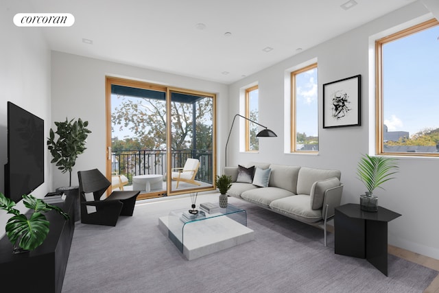 living area with baseboards, plenty of natural light, and visible vents