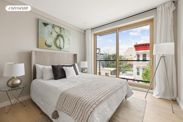 68 Eldert St Unit 3B, New York City, NY 11207 - bedroom featuring multiple windows, light wood-type flooring, and baseboards