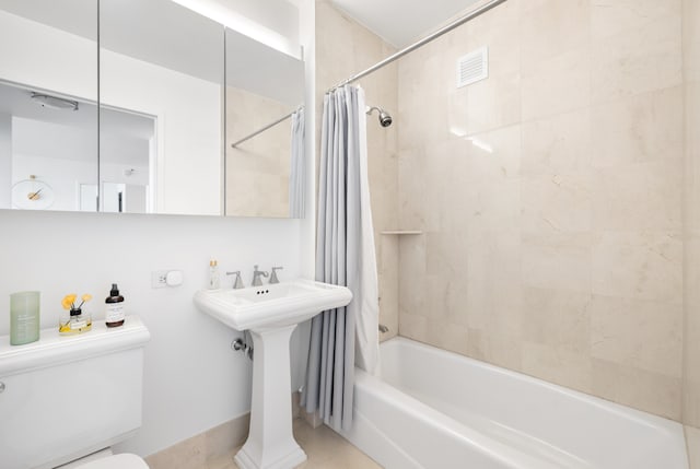 20 River Ter Unit 11L, New York City, NY 10282 - bathroom featuring toilet, shower / bath combination with curtain, a sink, and tile patterned flooring