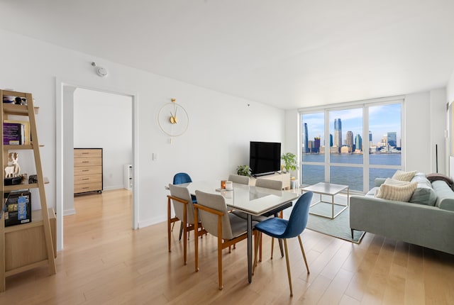20 River Ter Unit 11L, New York City, NY 10282 - dining space featuring light wood-type flooring