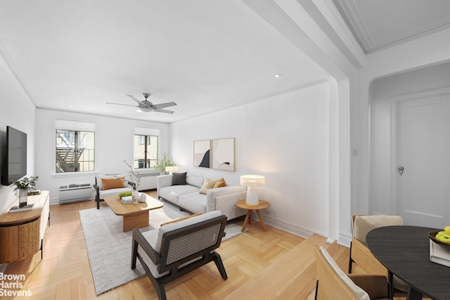 living room with crown molding, baseboards, a baseboard radiator, and a ceiling fan