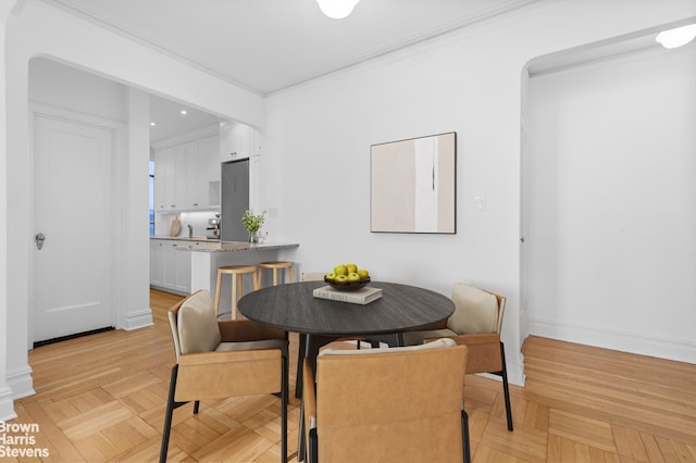 dining space with crown molding and recessed lighting