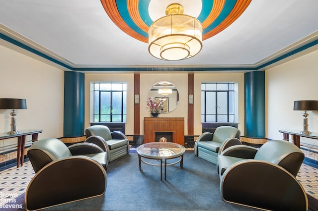 interior space featuring a raised ceiling, a fireplace, and carpet flooring