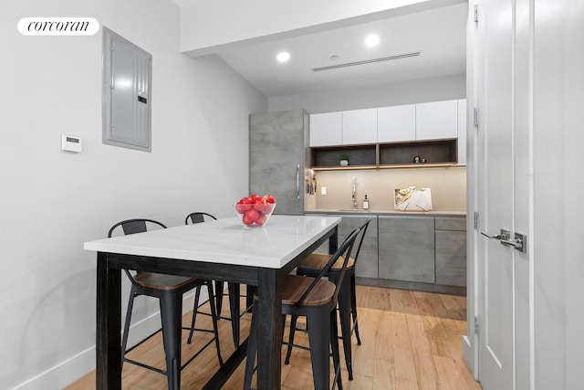 519 Maple St Unit 1B, New York City, NY 11225 - dining room featuring electric panel, light wood-style floors, and recessed lighting