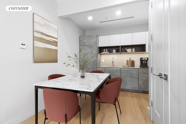 kitchen featuring open shelves, light wood-style flooring, white cabinets, modern cabinets, and recessed lighting