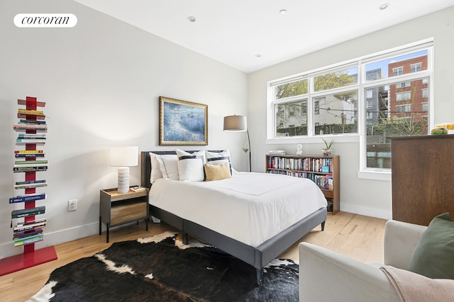 bedroom featuring light wood-style floors and baseboards