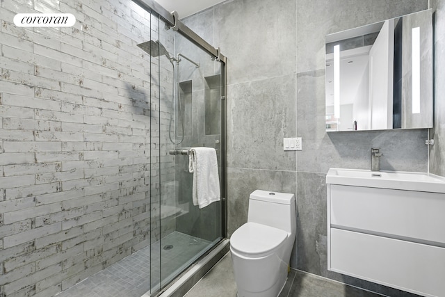 bathroom featuring vanity, a shower stall, and toilet