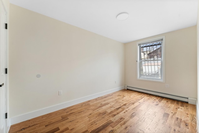 2108 Dean St, New York City, NY 11233 - unfurnished room with a baseboard heating unit, light wood-style flooring, and baseboards