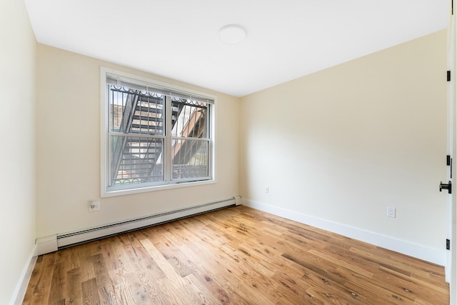2108 Dean St, New York City, NY 11233 - unfurnished room featuring baseboard heating, wood finished floors, and baseboards