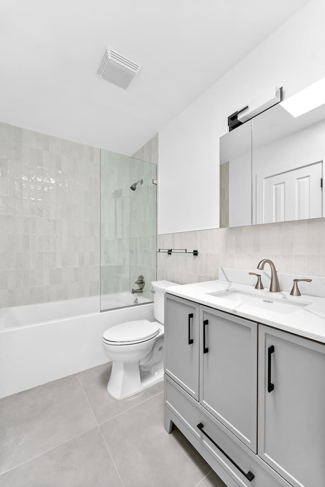 2108 Dean St, New York City, NY 11233 - full bathroom featuring vanity, toilet, tile patterned flooring, tub / shower combination, and tile walls