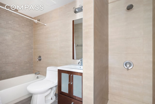 full bath with vanity, shower / bathing tub combination, toilet, and tile walls