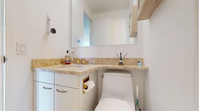 bathroom featuring toilet and vanity