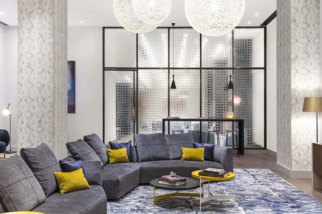 living room featuring baseboards, wallpapered walls, and expansive windows