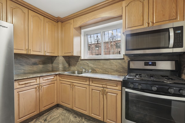 kitchen featuring light countertops, a sink, backsplash, and stainless steel appliances