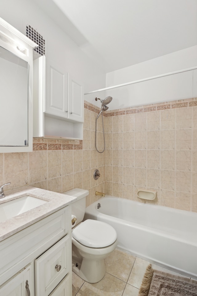 full bathroom with tile patterned flooring, vanity, toilet, tile walls, and shower / bathing tub combination