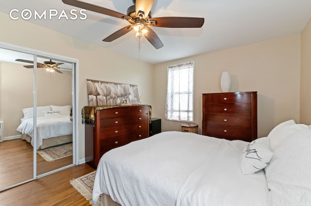bedroom with a closet, a ceiling fan, and wood finished floors