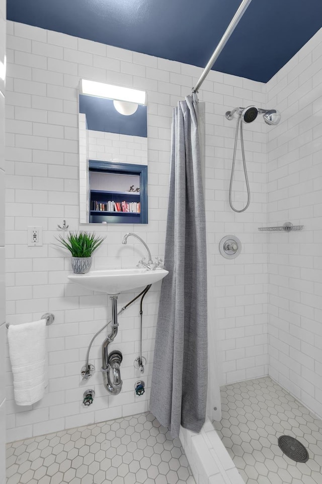 bathroom with tile patterned flooring and a stall shower