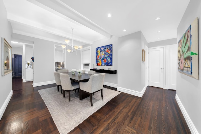 dining area with recessed lighting, baseboards, an inviting chandelier, and dark wood-type flooring
