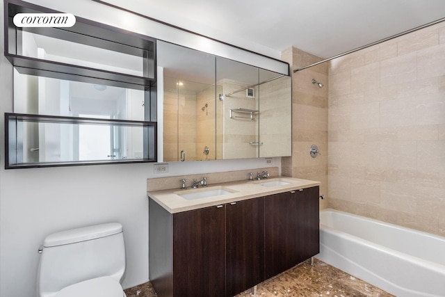 bathroom featuring toilet, washtub / shower combination, and double vanity