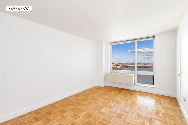 spare room with baseboards