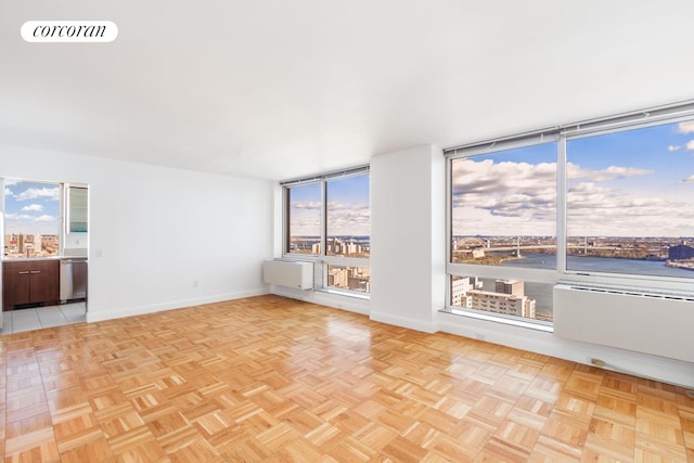 unfurnished room with baseboards