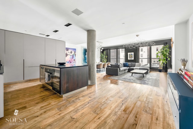 kitchen featuring light wood-type flooring, modern cabinets, and an inviting chandelier
