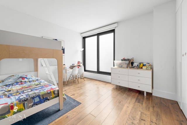 bedroom with wood-type flooring