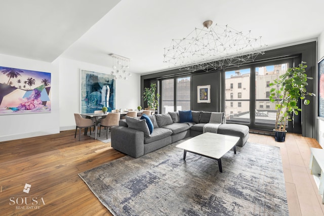 living area featuring an inviting chandelier and wood-type flooring