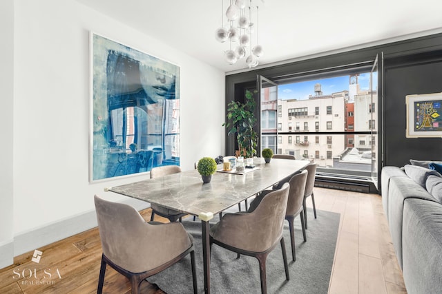 dining room with a view of city and light wood-style flooring