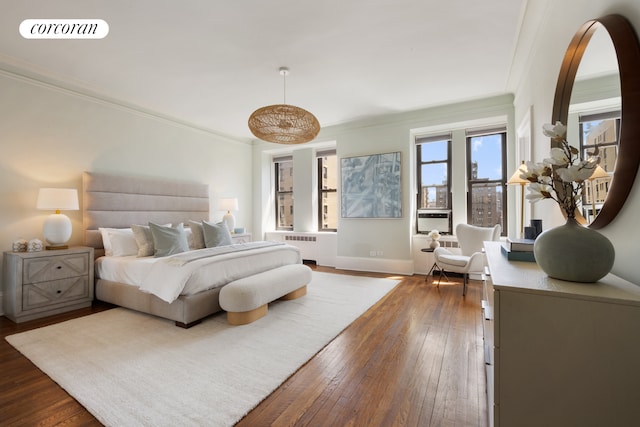 bedroom with crown molding, radiator, baseboards, visible vents, and dark wood-style floors