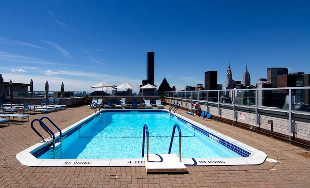 pool with fence and a patio area