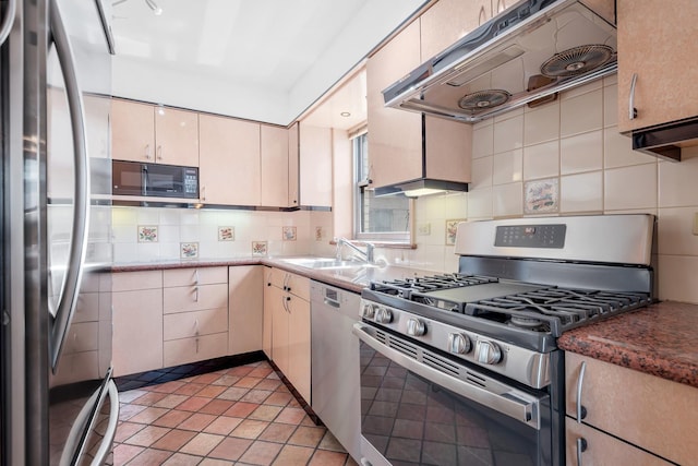 kitchen featuring light tile patterned flooring, a sink, stainless steel appliances, backsplash, and under cabinet range hood