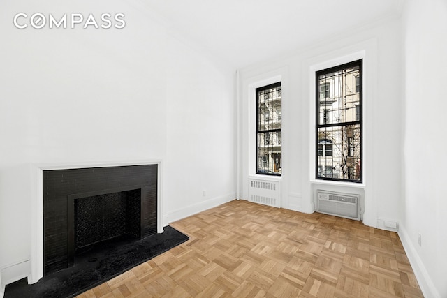 134 W 80th Street Parlor, New York City, NY 10024 - unfurnished living room with baseboards, a fireplace with flush hearth, a wall mounted air conditioner, and radiator heating unit
