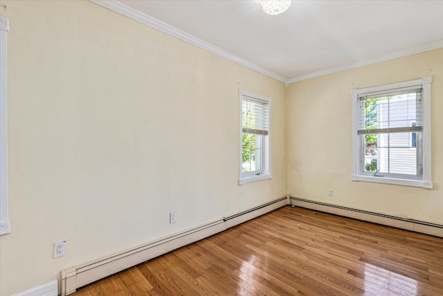 21-09 48th St, New York City, NY 11105 - spare room featuring plenty of natural light, crown molding, wood finished floors, and a baseboard heating unit