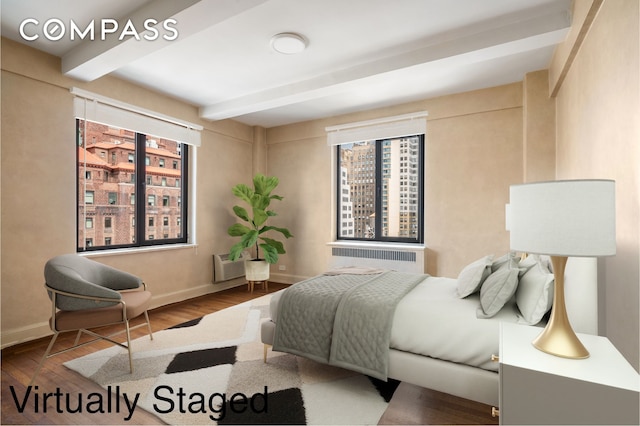 50 Park Ave Unit 15B, New York City, NY 10016 - bedroom with radiator heating unit, beamed ceiling, wood finished floors, and baseboards