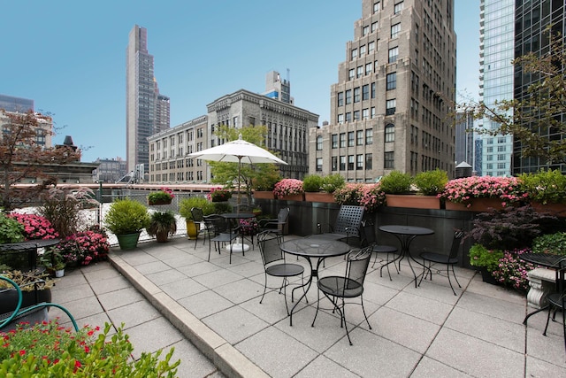 view of patio / terrace featuring a view of city and outdoor dining space