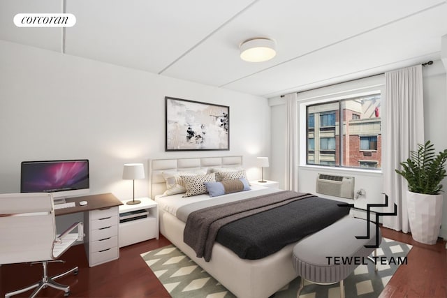 bedroom featuring an AC wall unit, dark wood finished floors, and visible vents