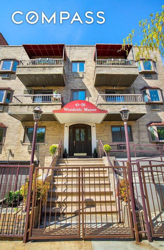 41-26 71st St Unit 1A, New York City, NY 11377 - view of exterior entry with fence and brick siding