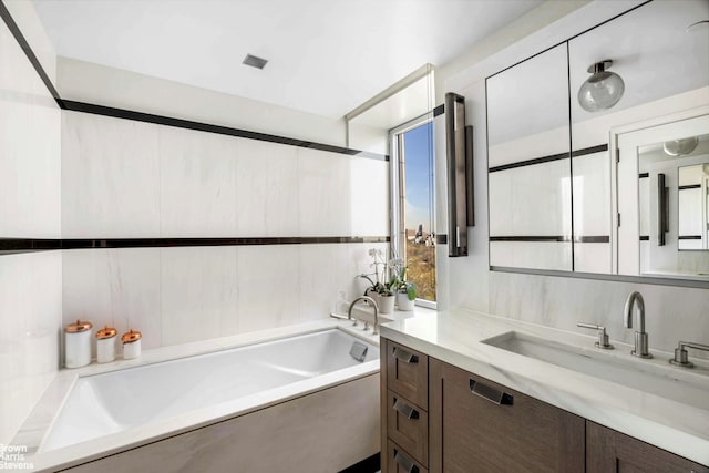 bathroom with a bath and vanity