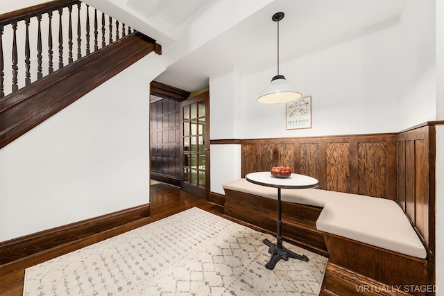 dining space with baseboards, wainscoting, and wood finished floors