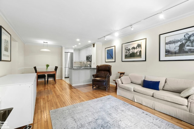 211 W 71st St Unit 2C, New York City, NY 10023 - living room with rail lighting, light wood-style floors, ornamental molding, and recessed lighting