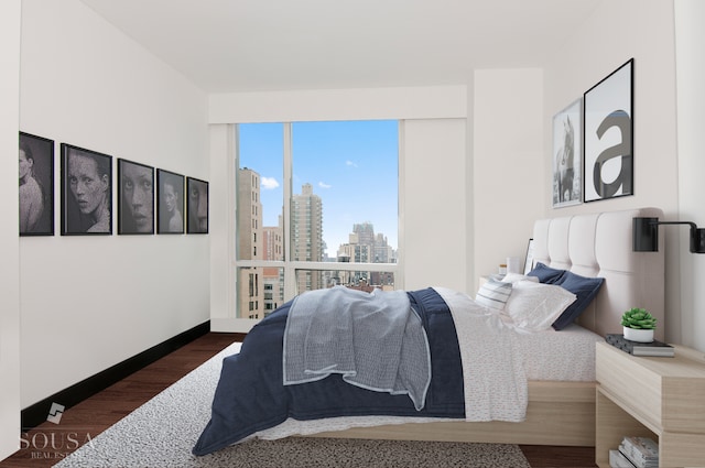 151 E 85th St Unit 12K, New York City, NY 10028 - bedroom featuring a skyline view and dark wood-type flooring
