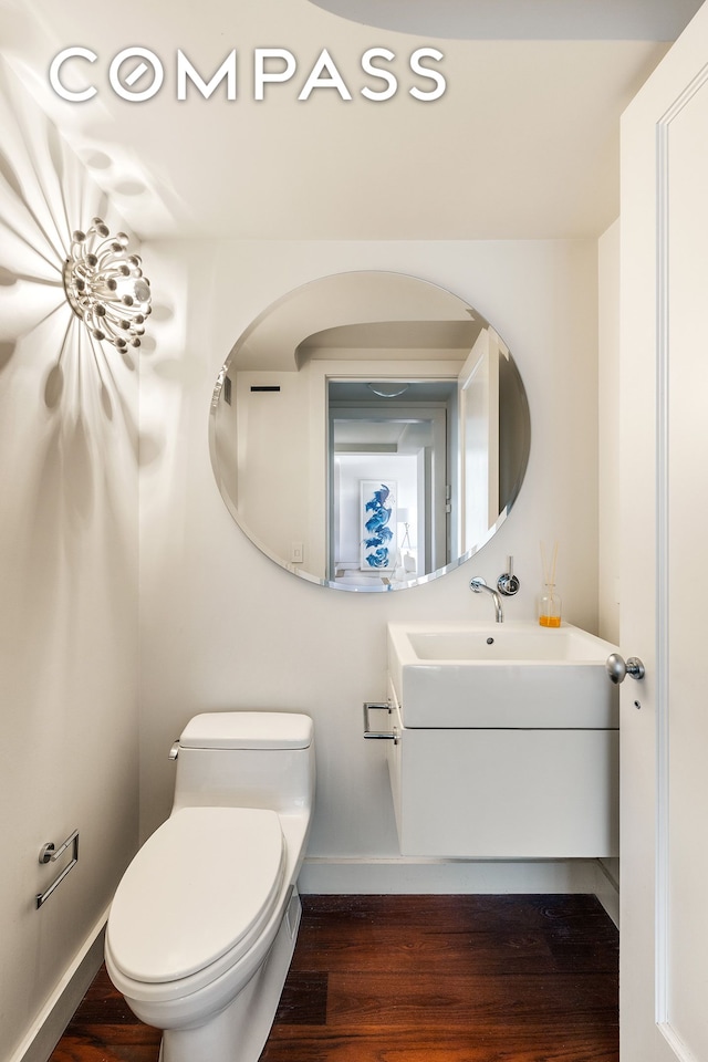 45 E End Ave Unit 6/7B, New York City, NY 10028 - bathroom featuring baseboards, vanity, wood finished floors, and toilet