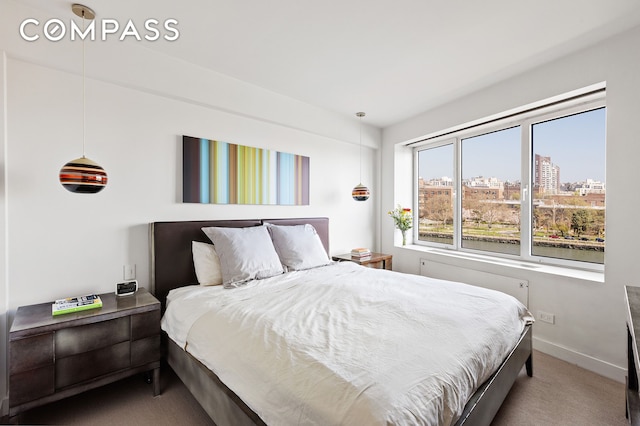 45 E End Ave Unit 6/7B, New York City, NY 10028 - carpeted bedroom featuring a city view and baseboards